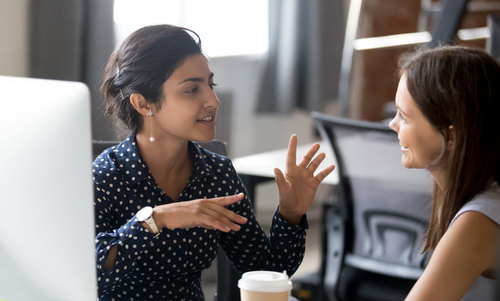 workers in a office talking