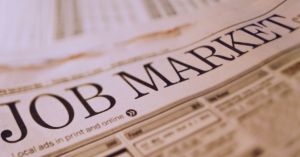 An image of the newspaper with a headline that reads "Job Market".