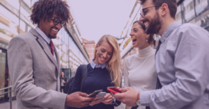 An image of four professionals smiling and mingling with each other.